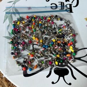 Bag full of different colored stud earrings.